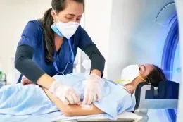 Clinician preparing a patient for an MRI