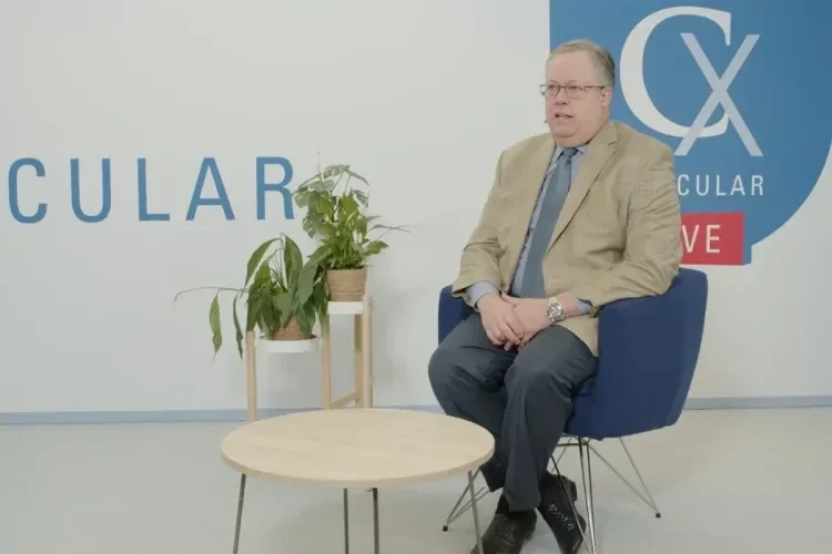 Photo of Dennis R. Gable, M.D. sitting on a chair during his talk