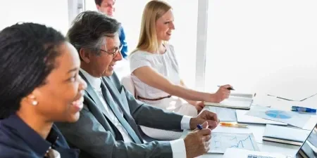 Three business people working with laptops