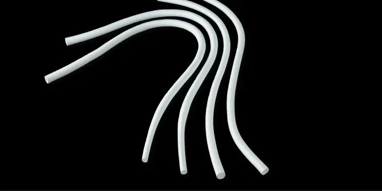 Four white GORE® INTERING® Vascular Grafts on black background