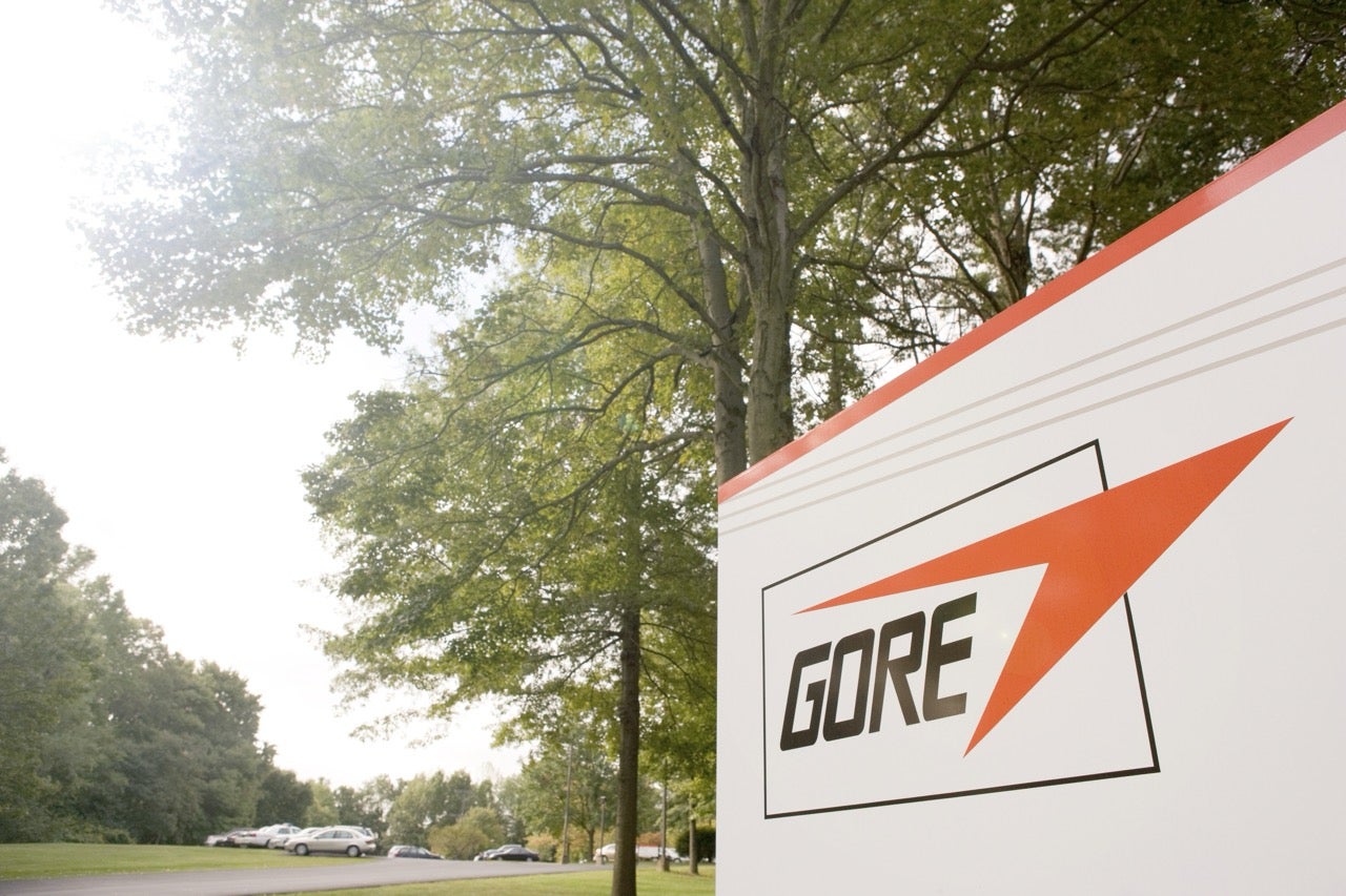 GORE logo on a red and white wall